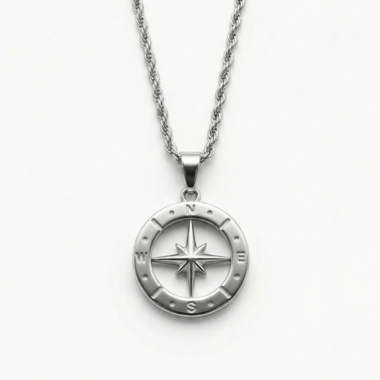 Close-up of the Polaris NSEW compass pendant featuring a polished stainless steel compass rose design and rope chain.