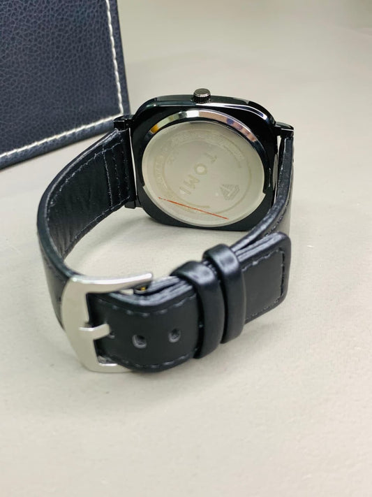 Back view of Tomy men's black leather analog watch with adjustable leather strap and stainless steel case back.
