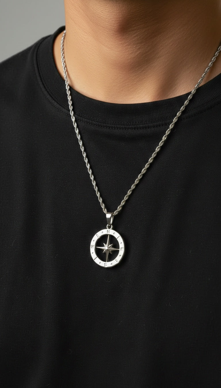 Man wearing the Polaris NSEW stainless steel compass pendant with a silver rope chain for a modern everyday look.
