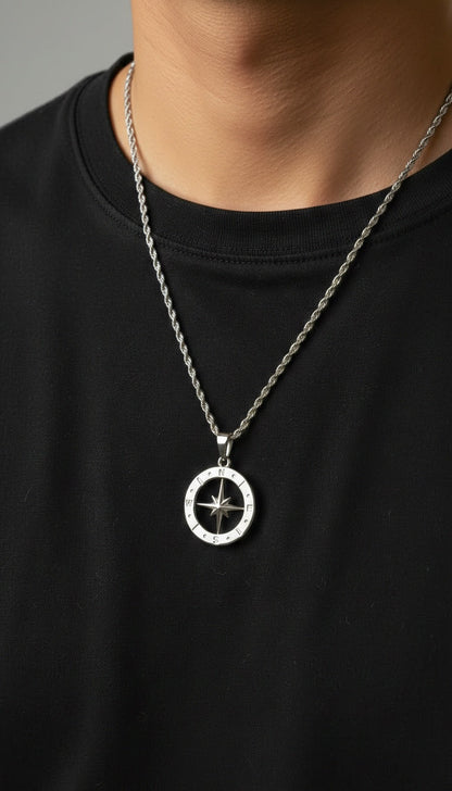 Man wearing the Polaris NSEW stainless steel compass pendant with a silver rope chain for a modern everyday look.