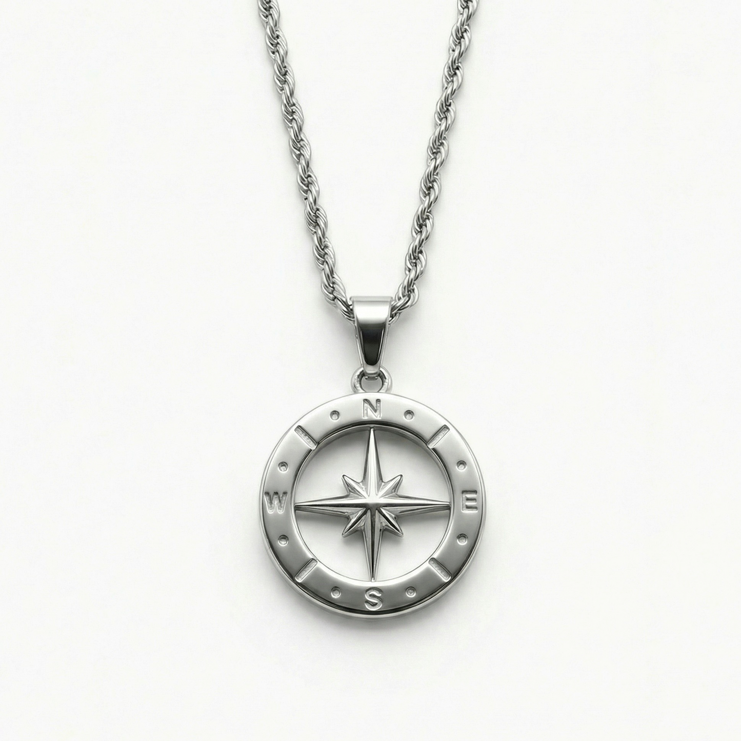 Close-up of the Polaris NSEW compass pendant featuring a polished stainless steel compass rose design and rope chain.