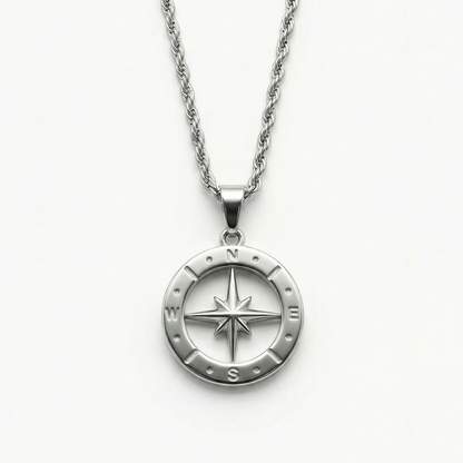 Close-up of the Polaris NSEW compass pendant featuring a polished stainless steel compass rose design and rope chain.
