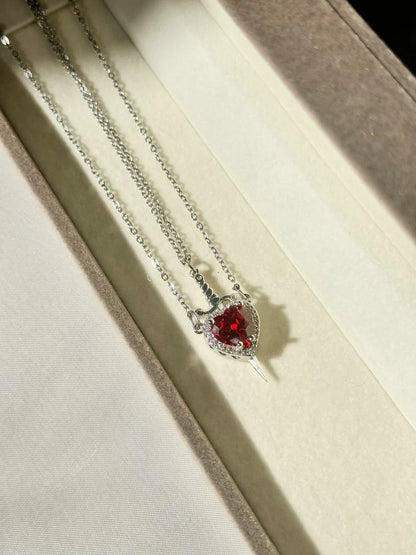 Red heart pendant necklace worn by a couple
