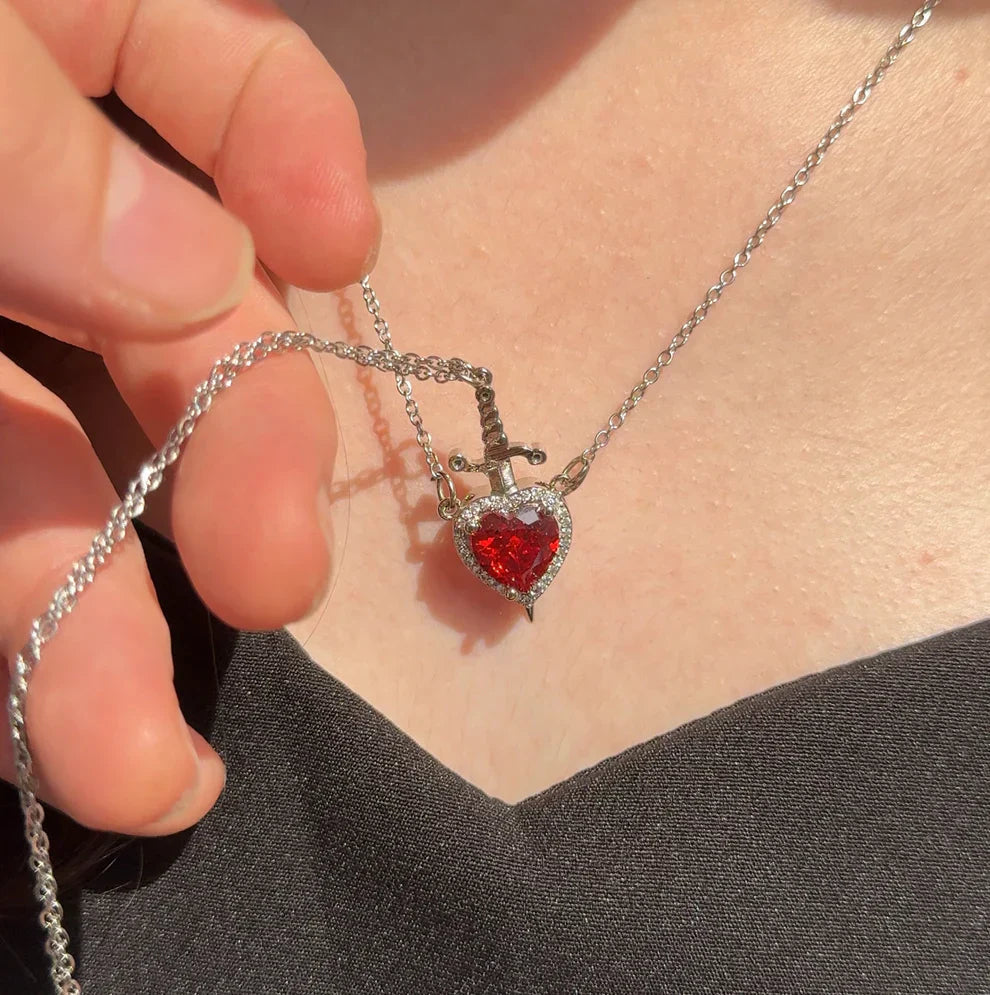 Red heart necklace with sparkling pendant worn on neck