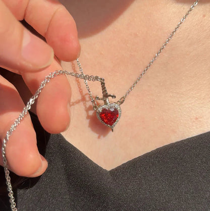 Red heart necklace with sparkling pendant worn on neck