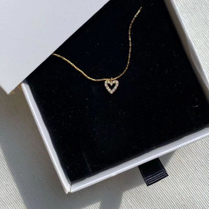 Tiny Diamond Heart Necklace in gold featuring a delicate heart pendant for women
